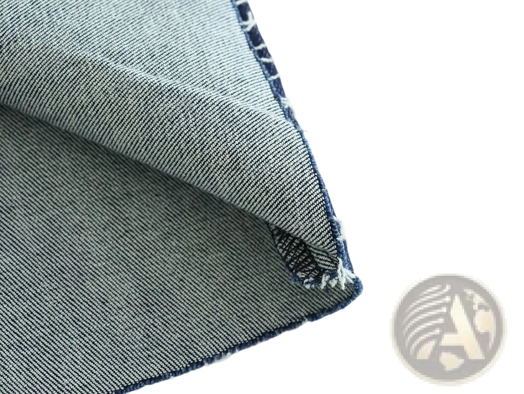 Close-up of faded blue denim fabric with stitching and frayed edges on high neck navy velvet zip front maxi dress