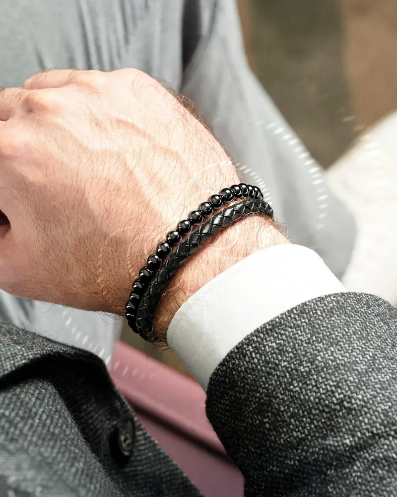 High power hematite and braided leather magnetic bracelet in black beads and leather worn on wrist
