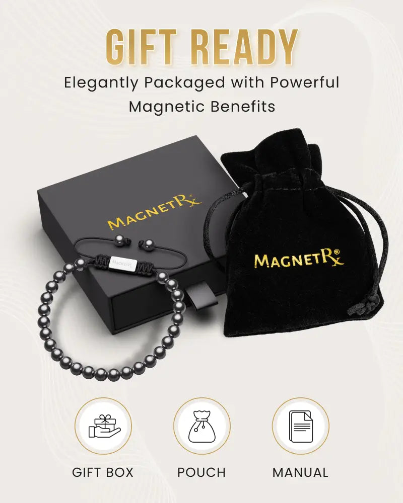 Black magnetic hematite bracelet with white rectangular clasp and steel charm displayed in elegant packaging