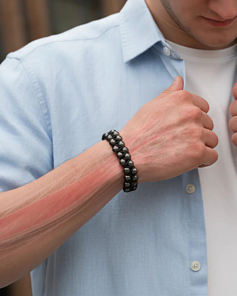 Black beaded double row magnetic hematite bracelet with braided design worn on a man’s wrist