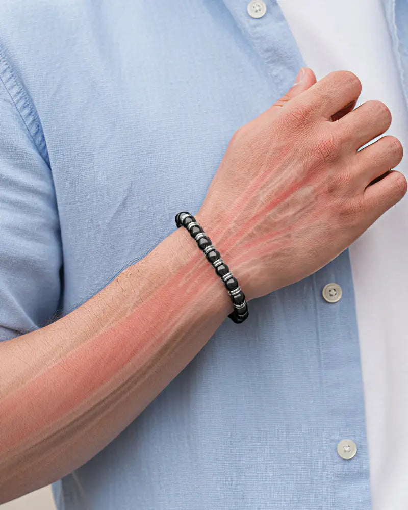 Silver titan magnetic hematite beaded bracelet in black and silver worn on wrist showcasing its elegant design
