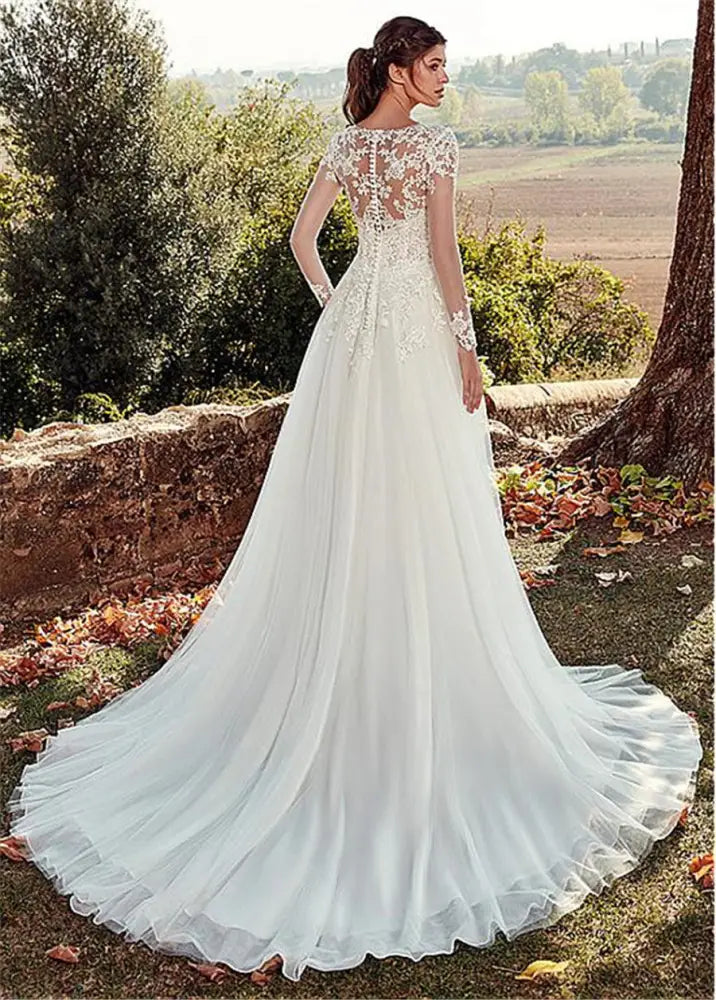 Back view of a white lace long sleeve a-line tulle wedding gown with intricate lace detailing and lightweight fabric