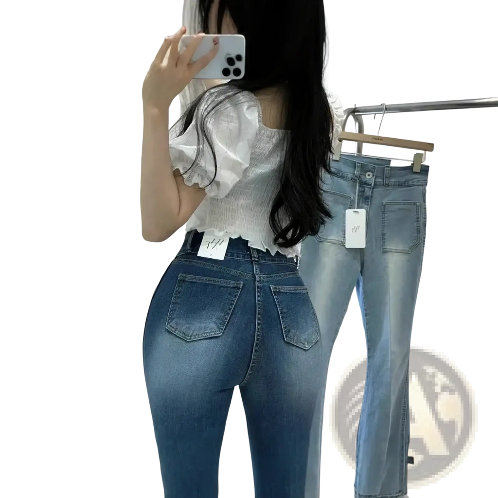 High-waisted blue denim jeans with a fitted tapered leg design and visible stitching details in cotton material