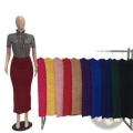A high waist slim fit midi skirt in rich red textured ribbed knit displayed on a mannequin