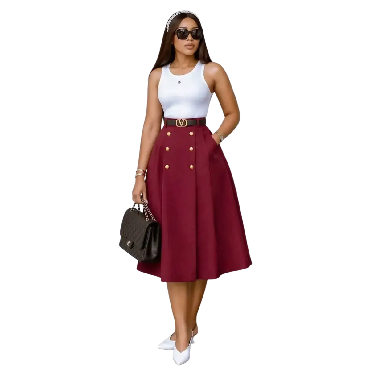 A woman wearing a maroon high waist knit midi skirt with gold buttons paired with a white sleeveless top