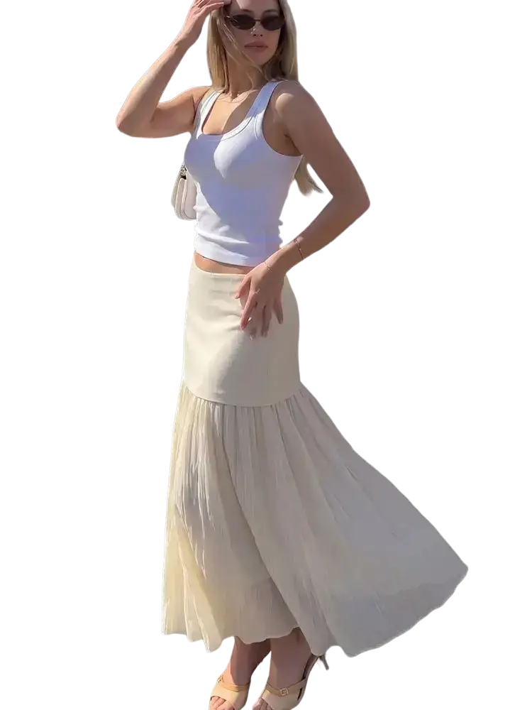 A flowing off-white high waist pleated long skirt with soft lightweight fabric and subtle tiered pleats