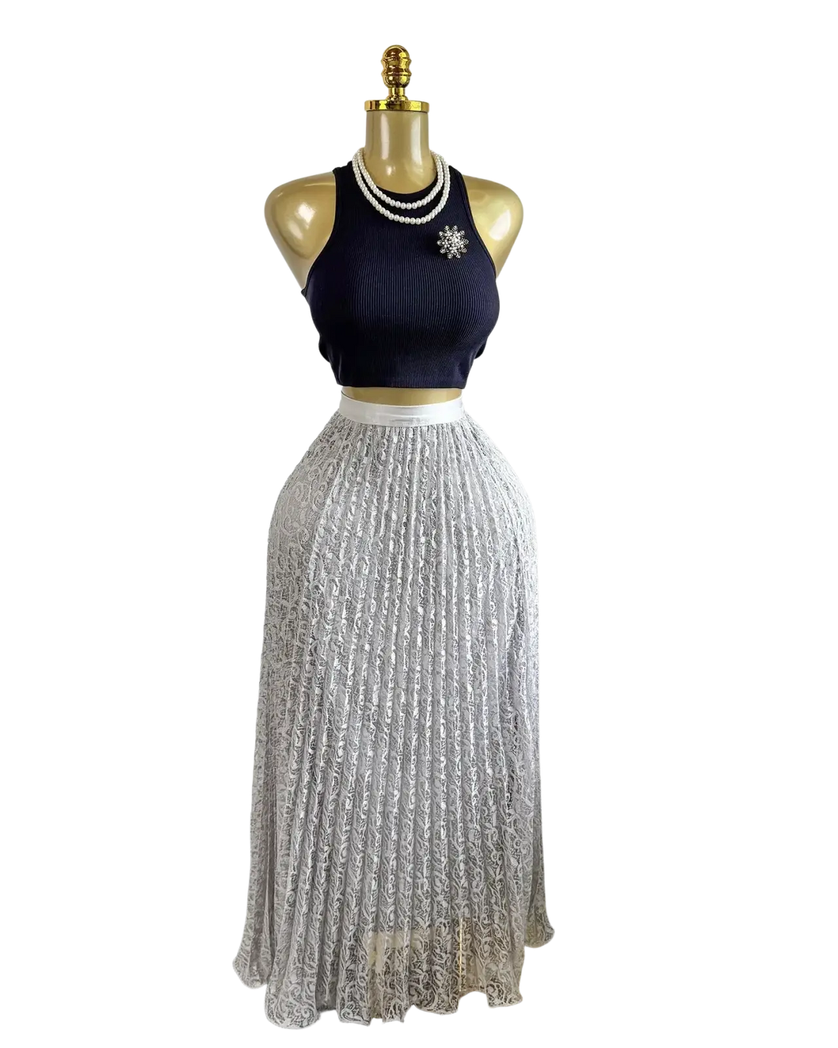A shimmering silver pleated high waist midi skirt with delicate lace detailing displayed on a mannequin