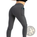 Gray high waist pocket bubble leggings with honeycomb texture and side pocket holding a phone for active wear
