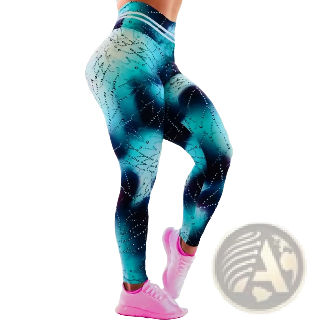 High waist printed yoga leggings in teal and black gradient with sparkling star-like embellishments shown from the back