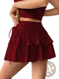 A deep red high waist ruffle skirt with tiered layers and a matching drawstring waistband for elegant wear