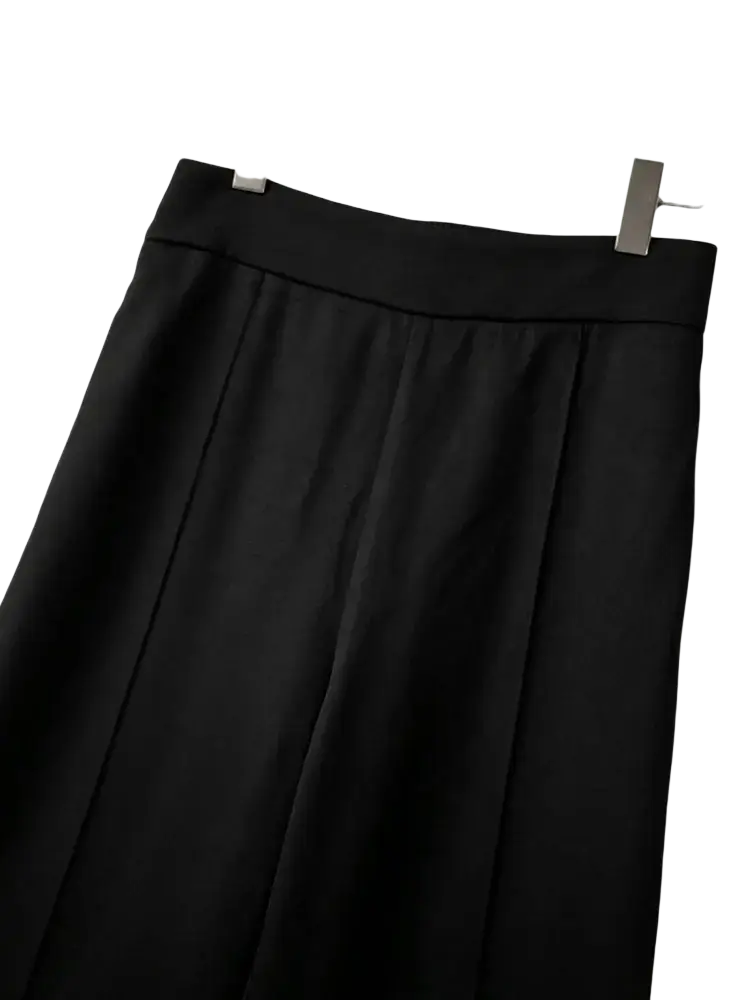 Black high waist wide leg trousers with a smooth tailored waistband and pleated skirt detail