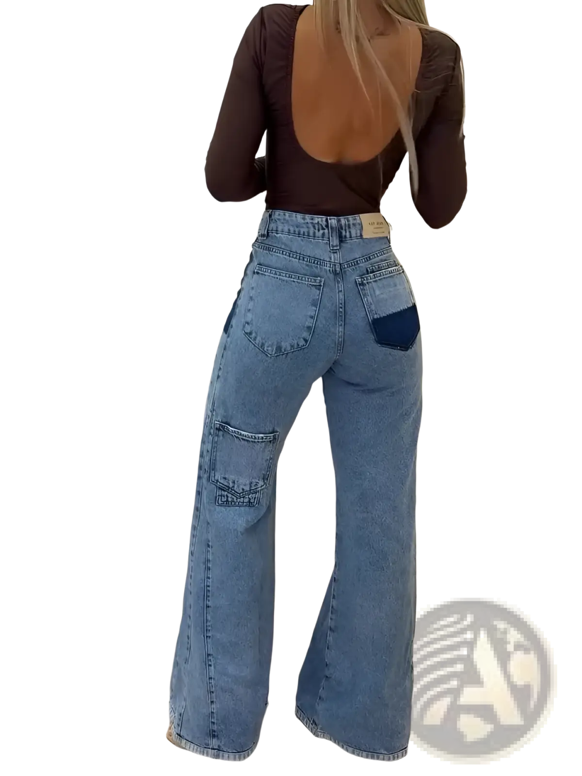 Back side of high waisted flared jeans in light blue denim with dark blue patch and large cargo pockets