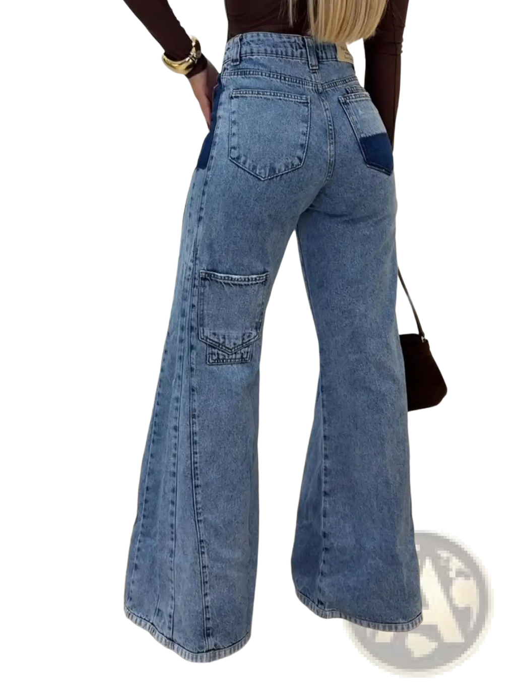 High waisted flared jeans in light blue denim with dark blue patch pockets and a classic wide-leg silhouette