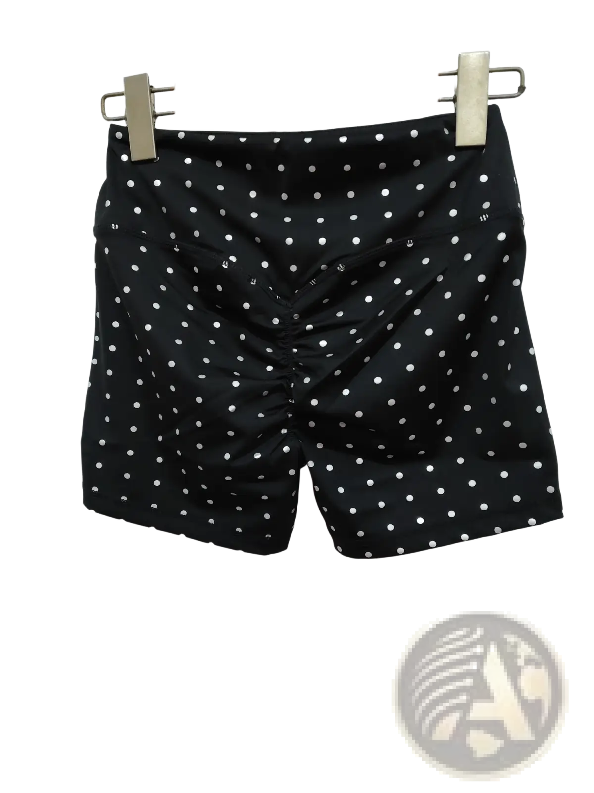 High waisted black cycling shorts with white polka dots made of smooth slightly shiny fabric