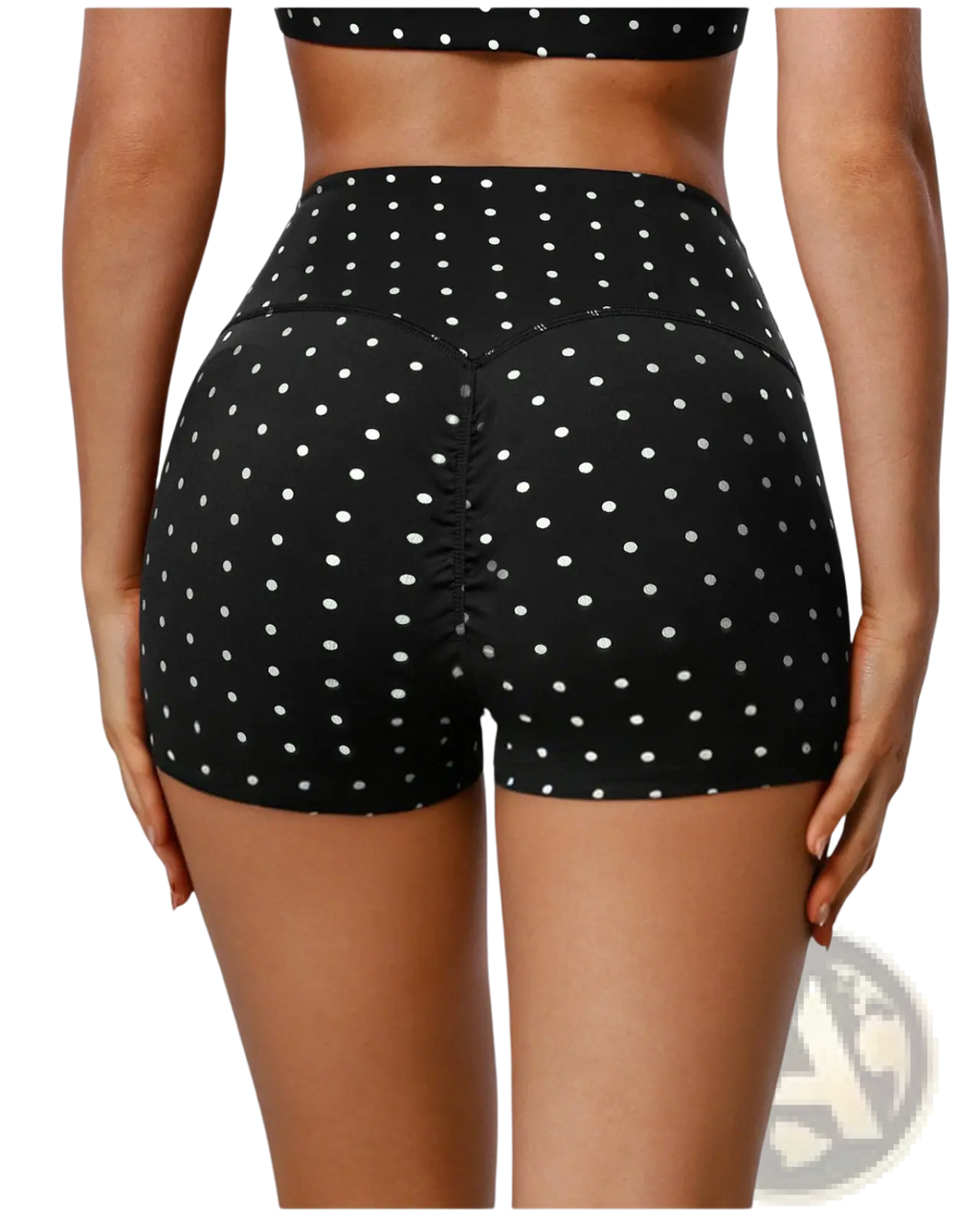 High waisted polka dot cycling shorts in black with white dots featuring a ruched back design shown from behind