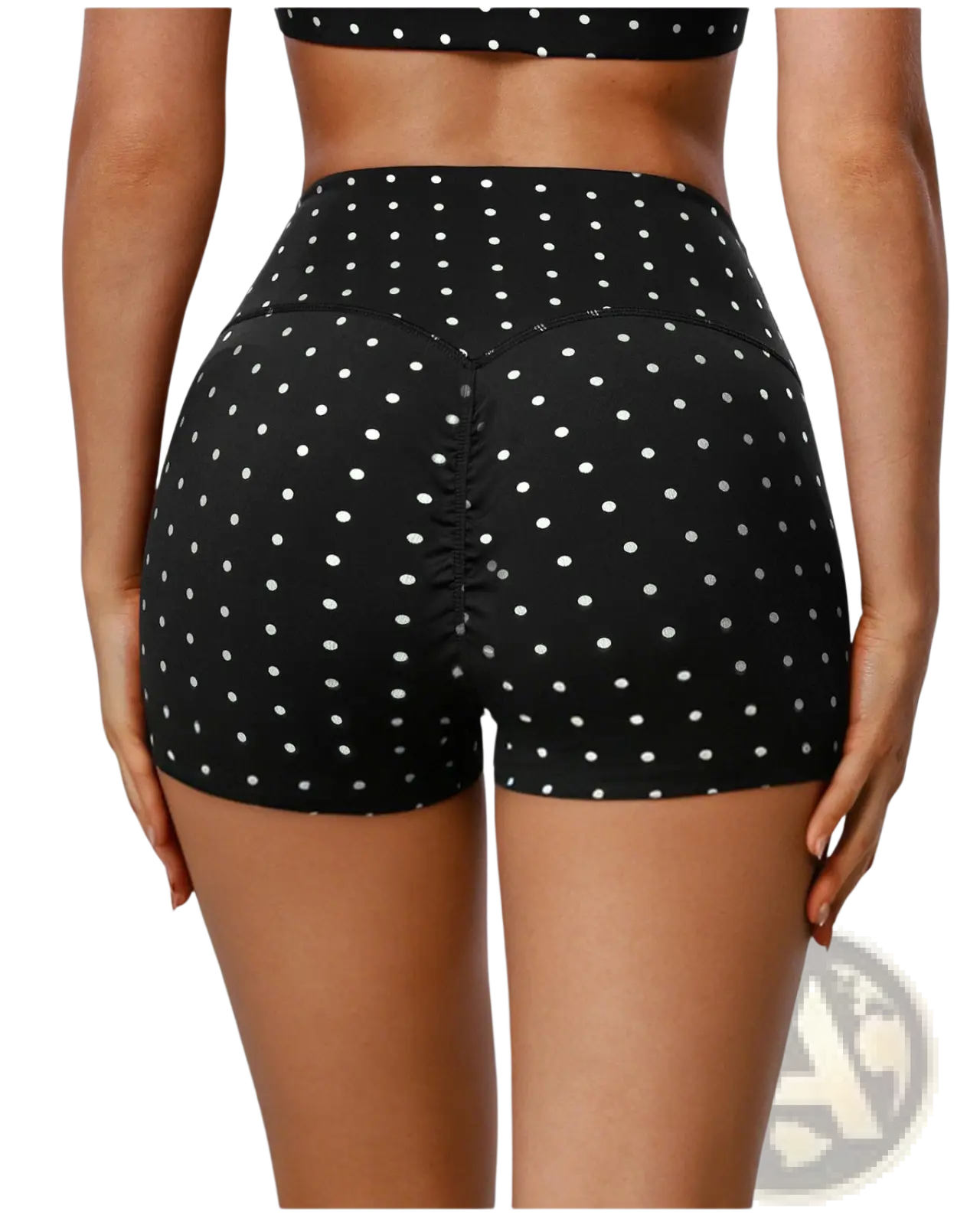 High waisted polka dot cycling shorts in black with white dots featuring a ruched back design shown from behind