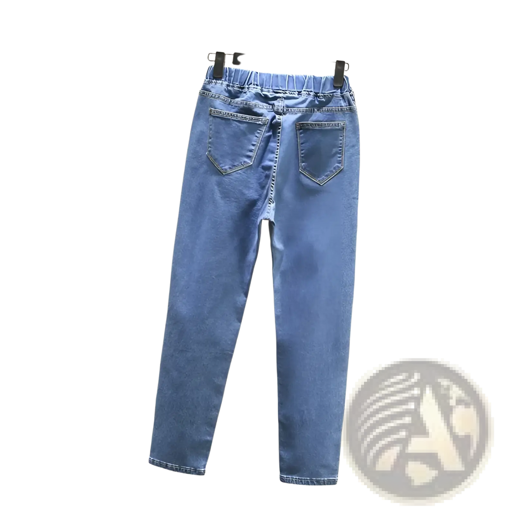 High waisted stretch light blue denim jeans shown from the back with elastic waistband and two back pockets