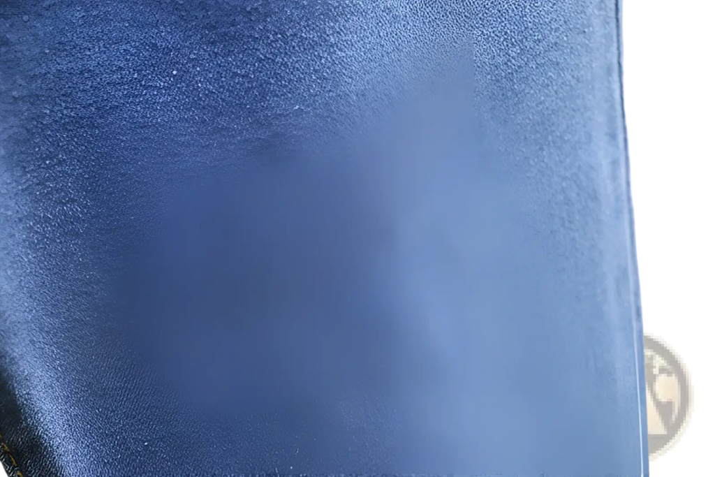 High waisted stretch light blue denim jeans fabric close up showing textured woven blue denim material
