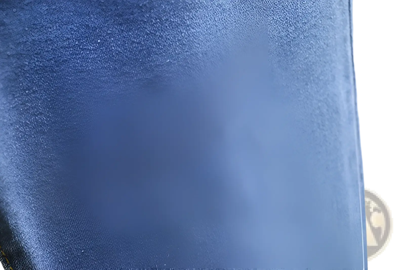 High waisted stretch light blue denim jeans fabric close up showing textured woven blue denim material