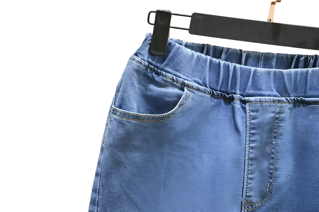 High waisted stretch light blue denim skirt with elastic waistband and front pockets in soft denim material