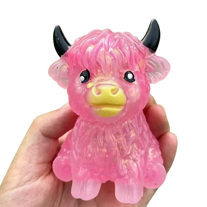 Pink translucent plastic highland cow sensory fidget toy with black horns and yellow snout for stress relief