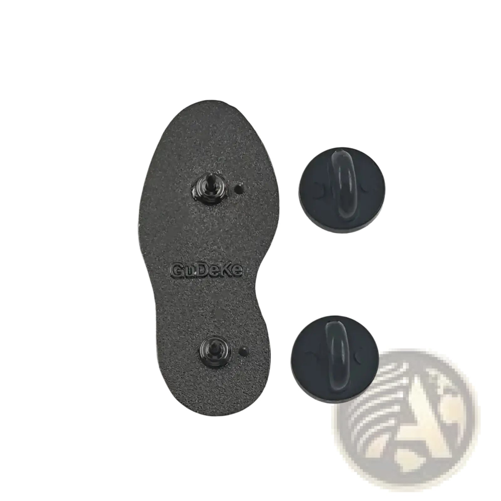 Backside of a black hiking boot sole enamel pin with two circular black backing pieces for adventure backpacks