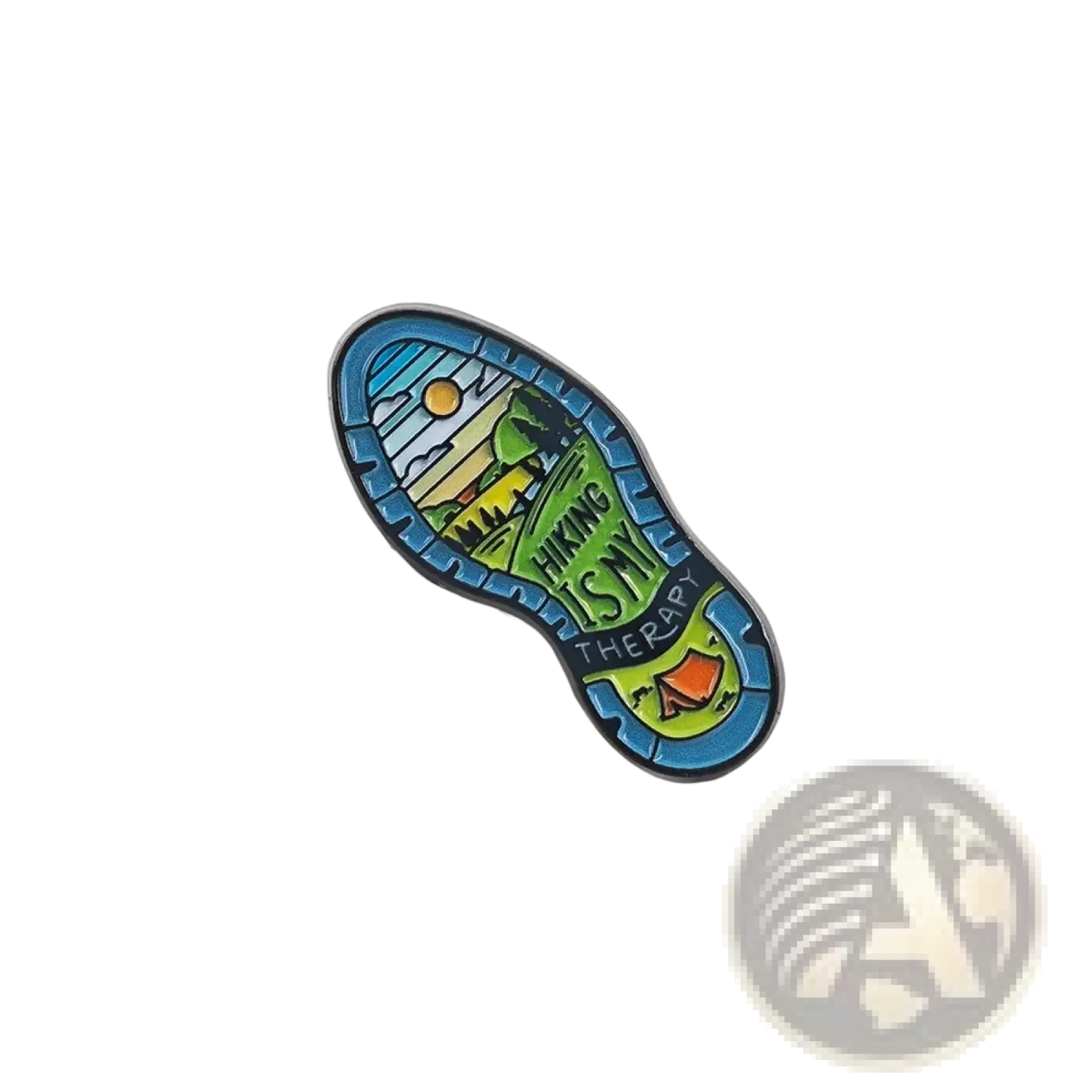 A colorful enamel hiking boot sole pin with a scenic landscape and hiking is my therapy text