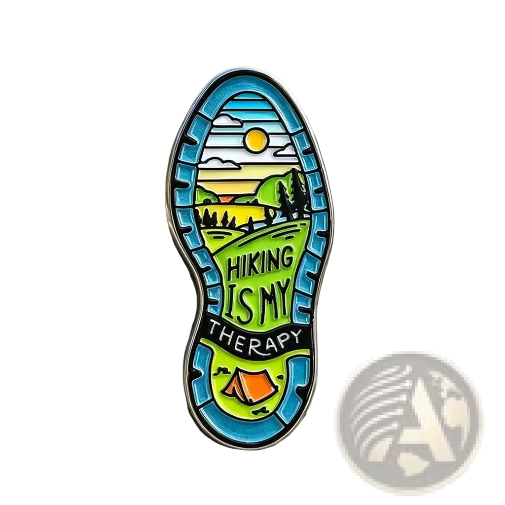 Colorful hiking boot sole enamel pin featuring a mountain campsite and hiking is my therapy text for backpacks