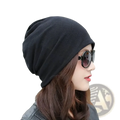 Black slouchy knit beanie hat with hip hop newspaper print design made of soft knit material for casual wear