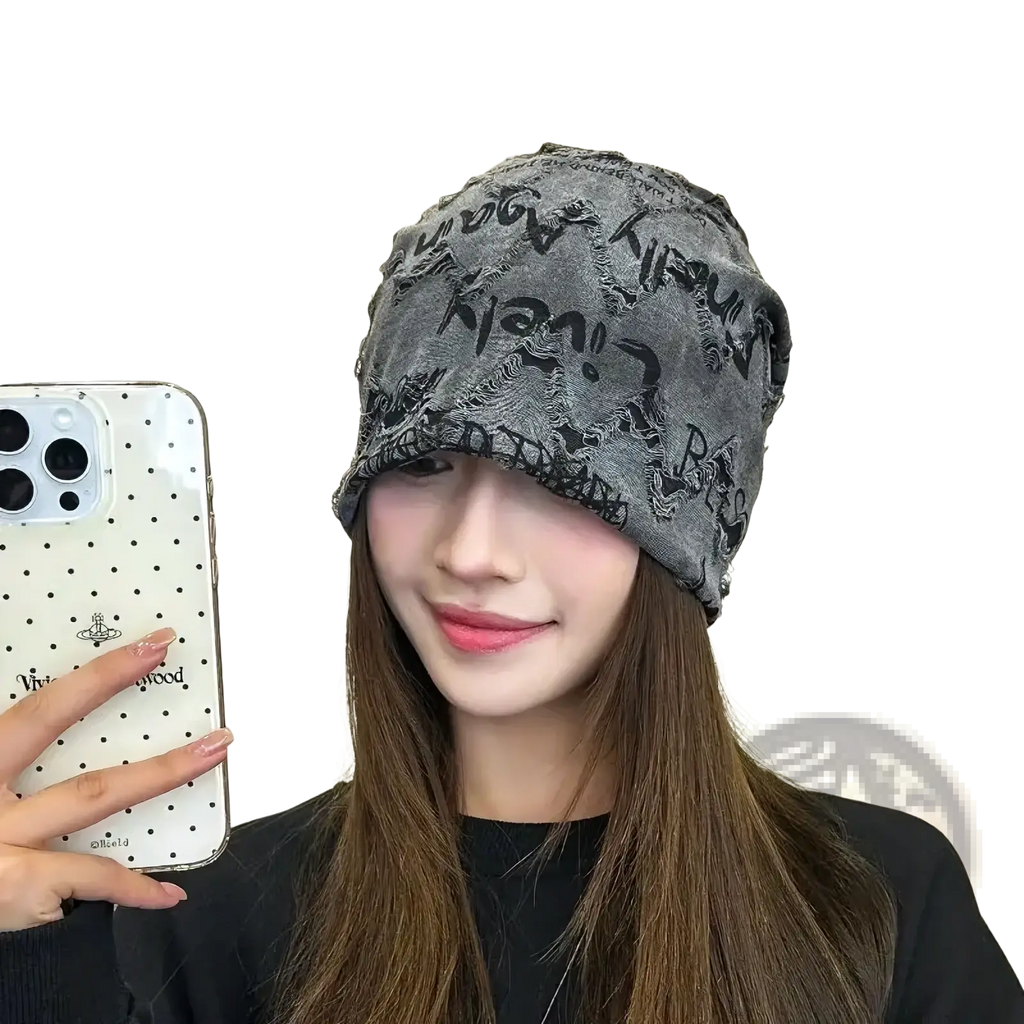 Gray knit hip hop beanie hat with black distressed newspaper print lettering design on soft fabric material