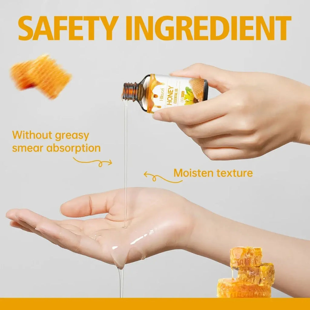 A small amber glass bottle of hloozzi honey essential oil 30ml with honeycomb and green leaf label by honda