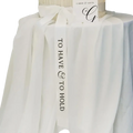White satin To have and to hold wedding ribbon band with black cursive text tied in a bow