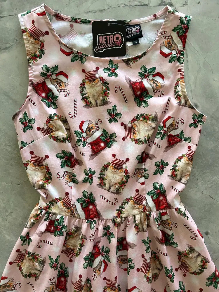 Pink cotton 1950s vintage midi dress with festive cats santa hats candy canes and holly pattern sleeveless design