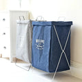 Embroidered denim laundry basket in blue with white metal frame white stitching and welcome to my house print on front