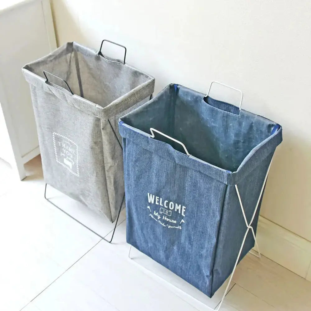 Blue denim embroidered laundry basket with white welcome to my house text and white metal wire frame base