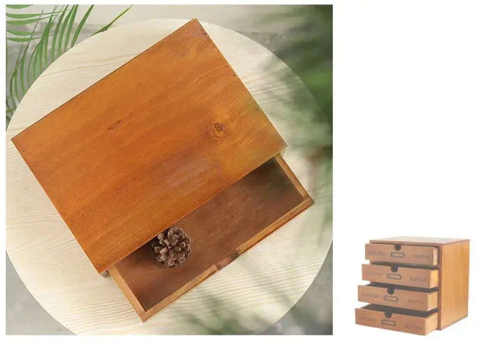 A rustic light brown wooden retro lockable storage box with a vintage drawer partially open containing a pinecone