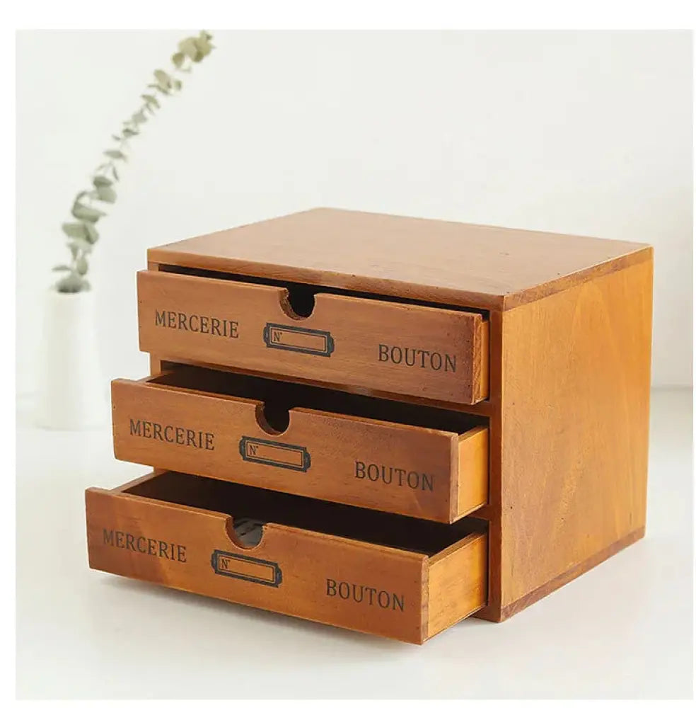 A rustic wooden three-drawer retro lockable storage box with a warm brown finish and labeled vintage drawers