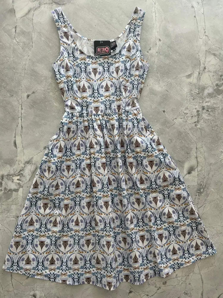 Sleeveless white retro cotton fit and flare dress with brown and blue circular pattern from Honey Im Home