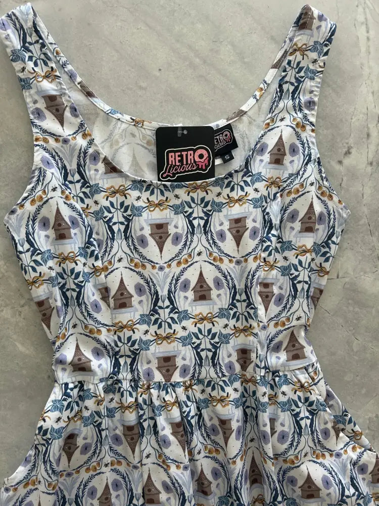 Honey I’m Home retro cotton fit and flare dress in white sleeveless design with brown birdhouse and blue gold foliage print