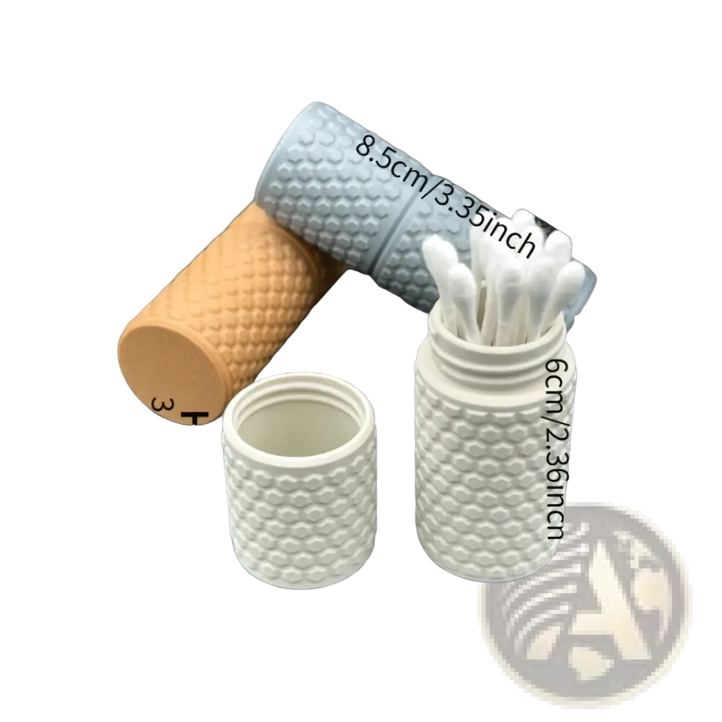 White ceramic honeycomb cotton swab holder with open top filled with swabs and matching lid beside it