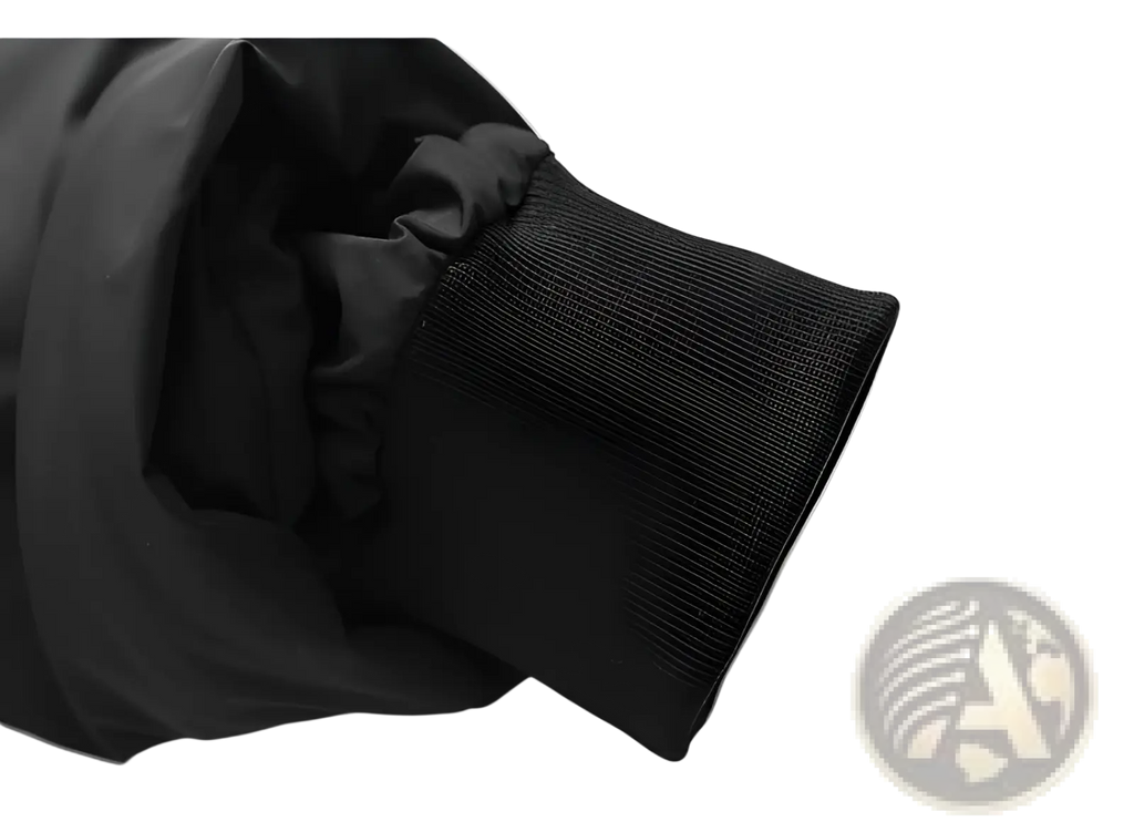 Black ribbed knit cuff on the sleeve of a hooded puffer cotton coat designed for warmth and comfort