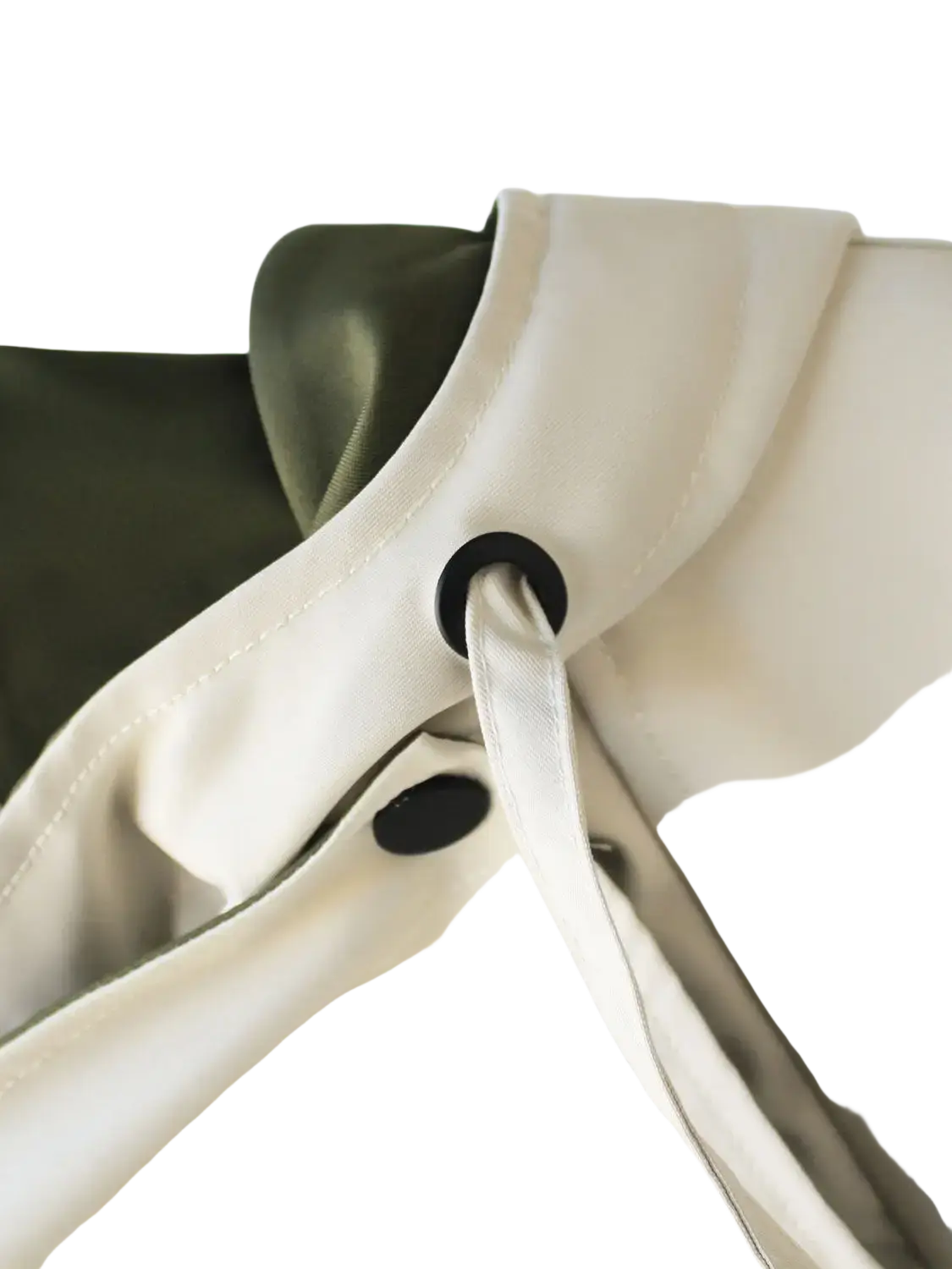 Cream-colored satin strap with black grommet detailing on hooded trench coat utility jacket accessory
