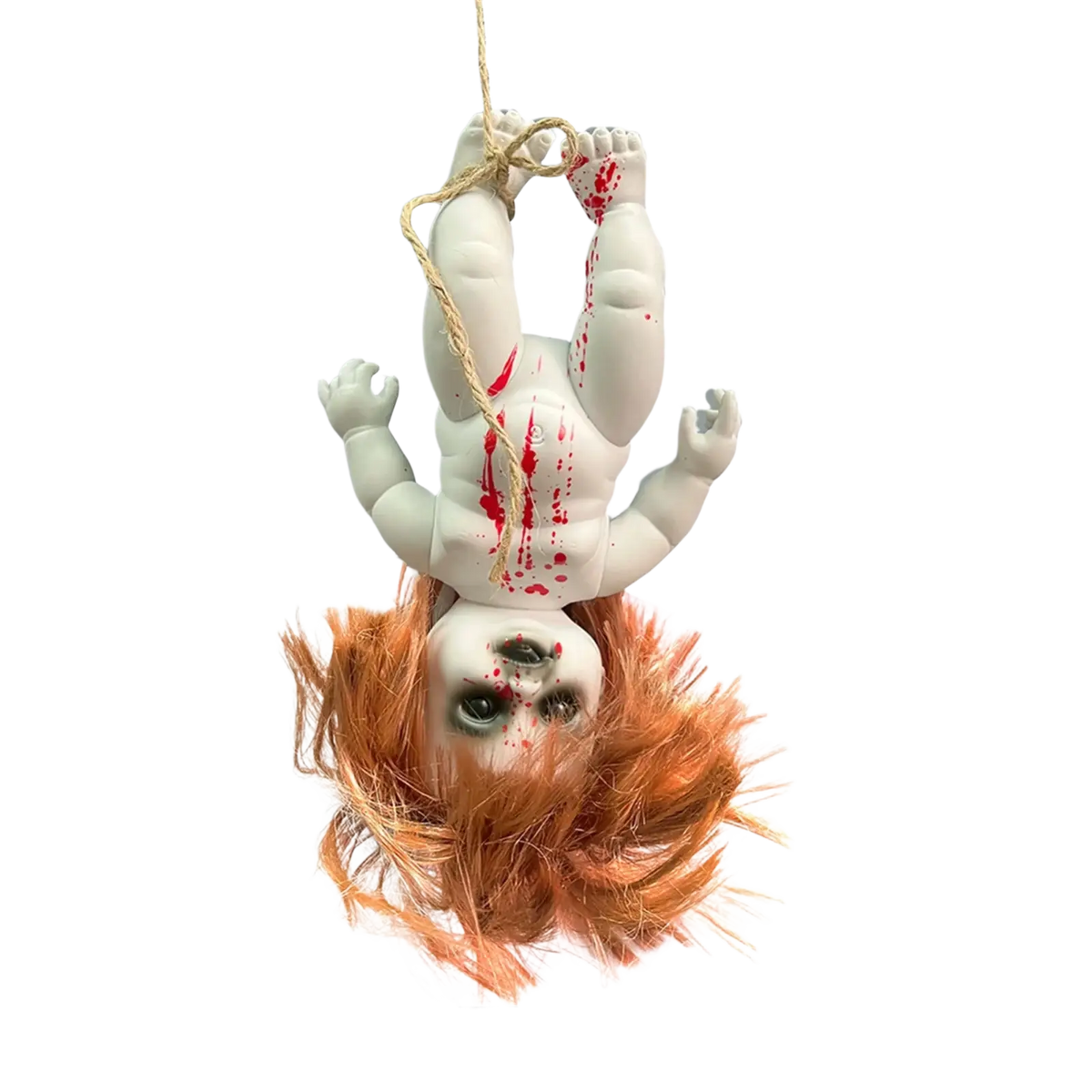 White plastic gothic horror doll with orange hair and red paint splatters hanging upside down by rope for halloween