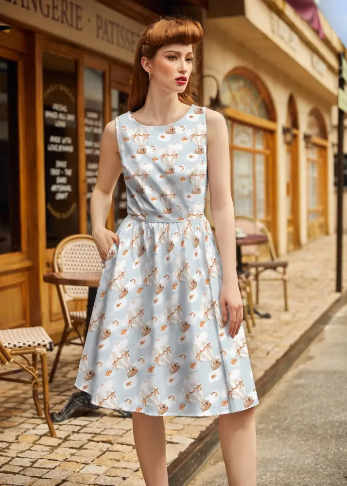 Light blue cotton vintage a-line dress with playful orange and brown hot air balloon pattern and sleeveless design