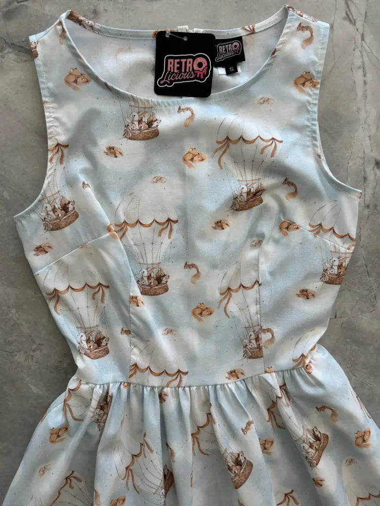 Sleeveless light blue cotton a-line dress with whimsical hot air balloon and small animal pattern and gathered waistline