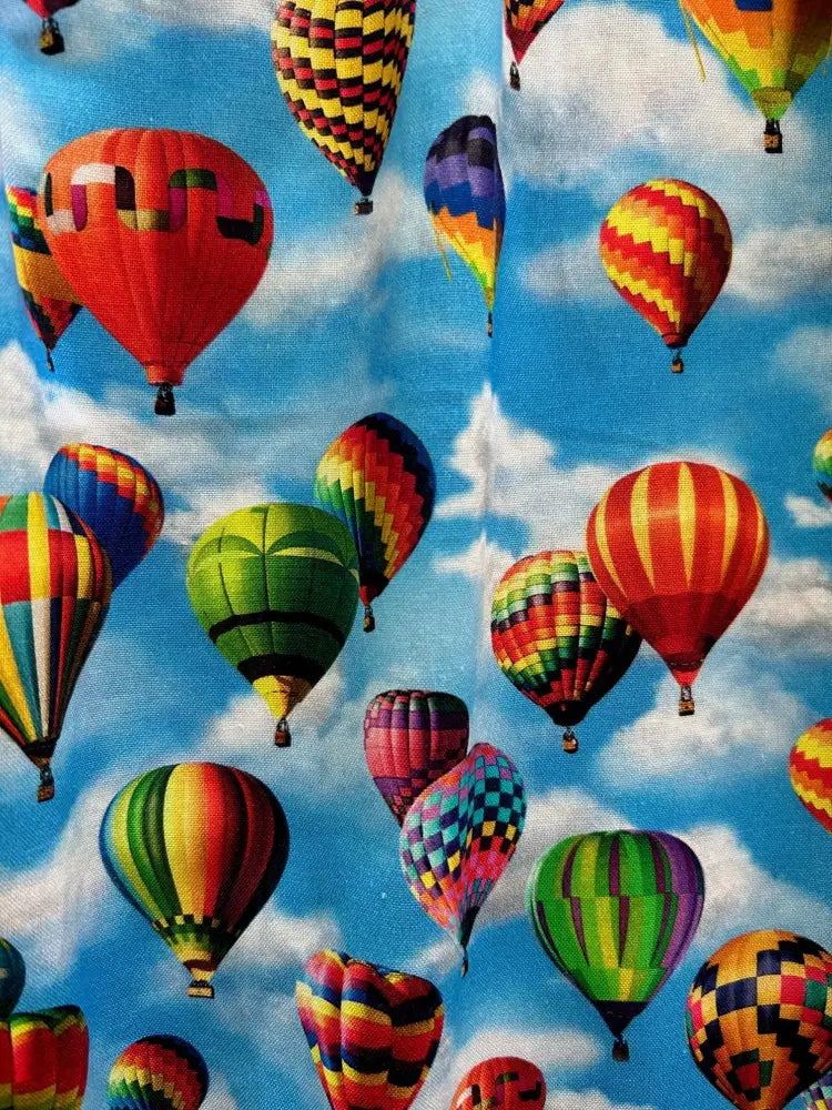 Vintage hot air balloon print cotton fit and flare dress featuring vibrant multicolored balloons against blue sky