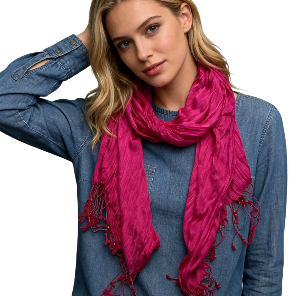 A vibrant hot pink crinkle scarf with soft textured fabric and frayed edges for stylish women accessory
