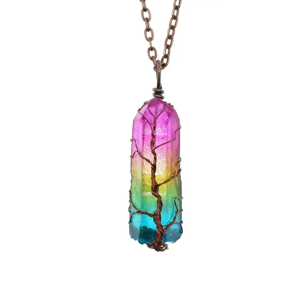 A vibrant rainbow-colored crystal pillar pendant necklace with wire-wrapped tree design on antiqued bronze chain