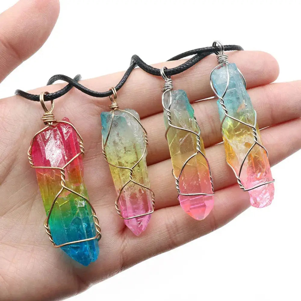 Four rainbow-colored crystal pillar pendant necklaces wrapped in wire on black cords for elegant wear