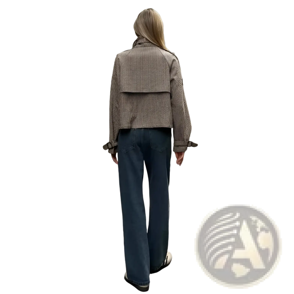 A woman wearing a beige and black houndstooth patterned relaxed fit double breasted jacket